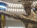 star_wars_solo_super_bowl_trailer_performer_in_gold_with_mic_and_mouthpiece_and_creature_in_glass_jar